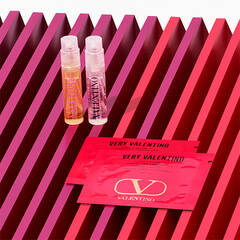Two samples of Valentino Fragrance on pink and red freckled background.