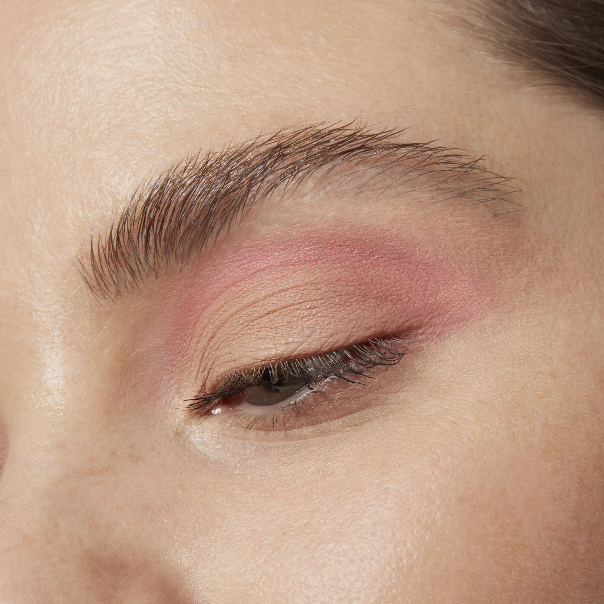 Close-up of an eye with pink eye shadow