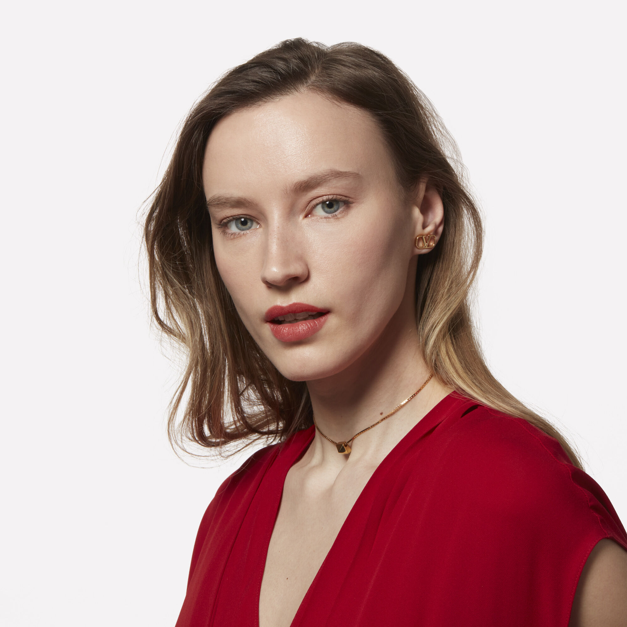 Woman with long blond hair wearing red lipstick