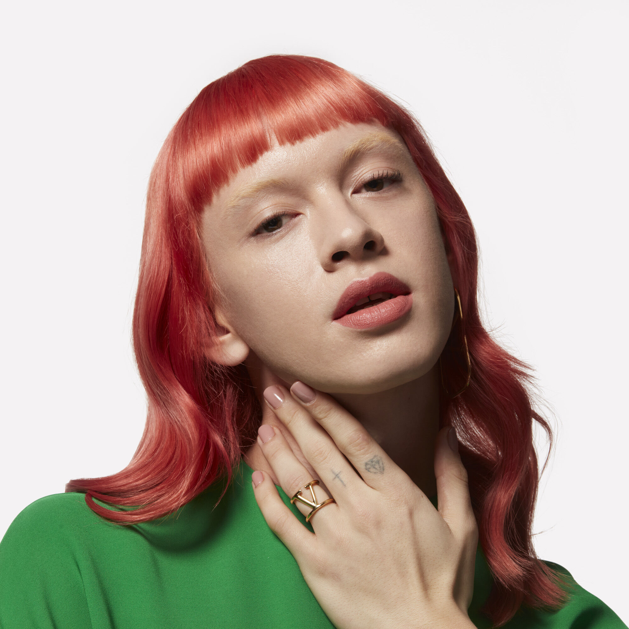 A model with long red hair and micro bangs