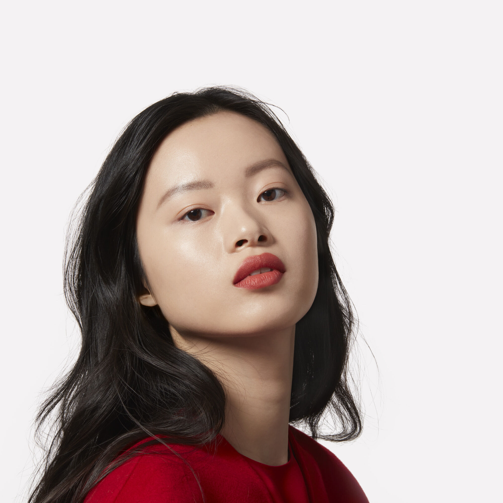 Woman with long black hair wearing red lipstick