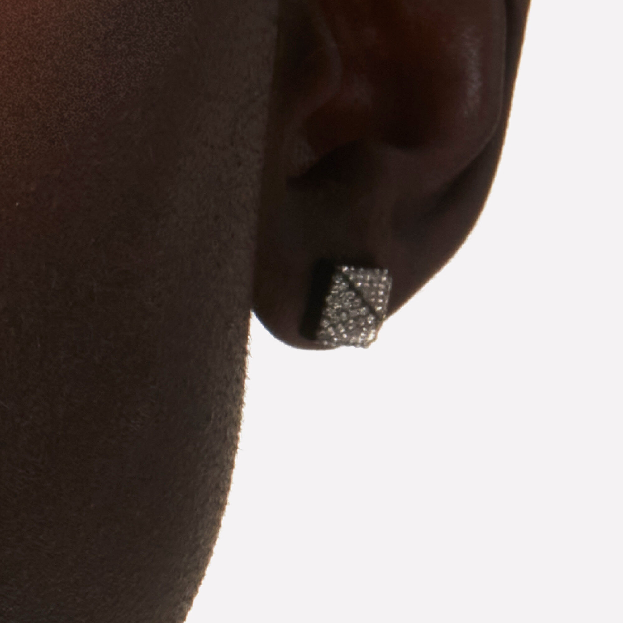 close-up of ear lobe with diamond stud earring