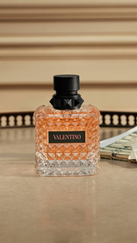 Bottle of BORN IN ROMA Coral Fantasy on tan granite table