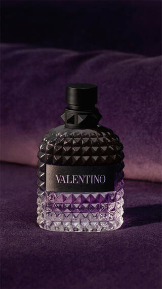 Bottle of BORN IN ROMA UOMO Purple Melancholia on purple velvet background