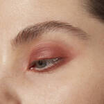 Close-up of aneye with mauve eye makeup