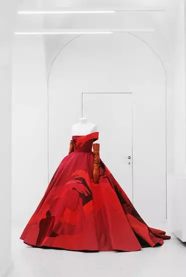 A mannequin bust wearing a red gown