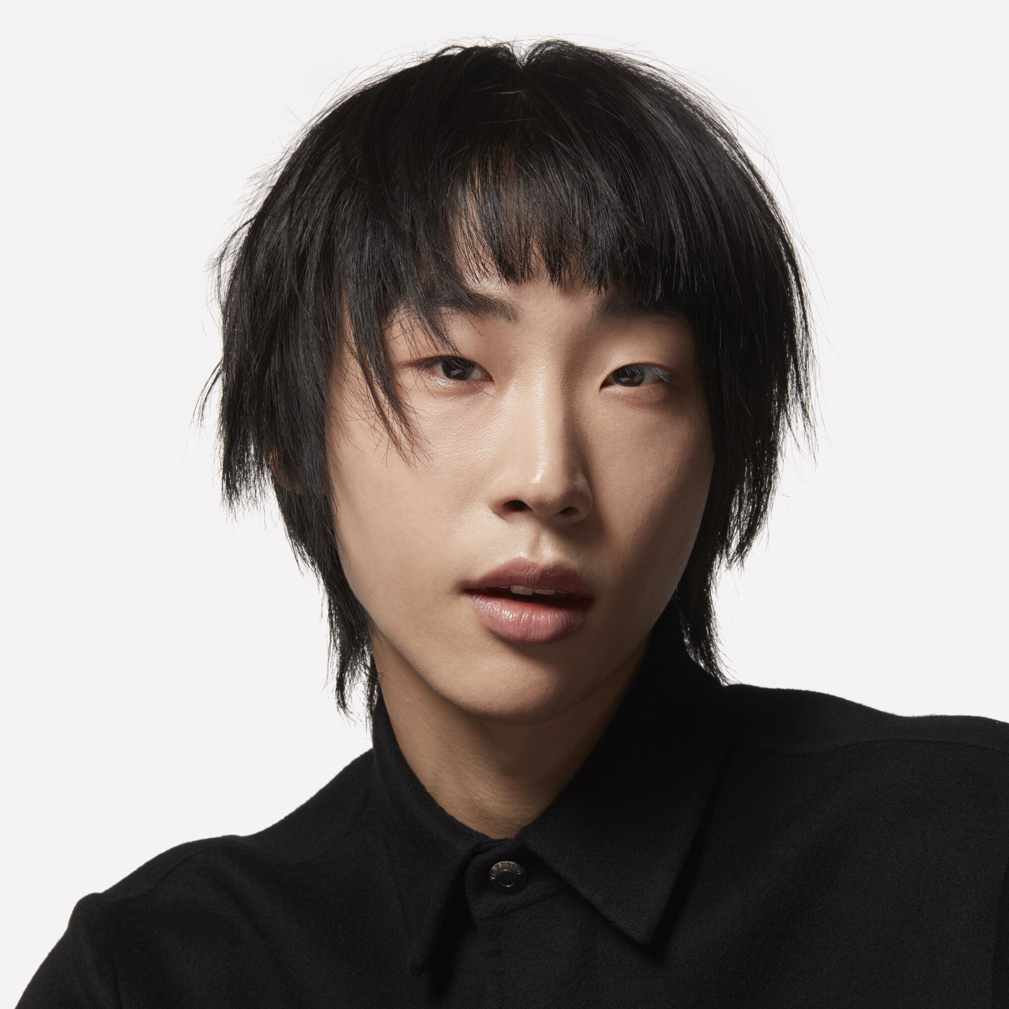 A model with black hair and an angular haircut
