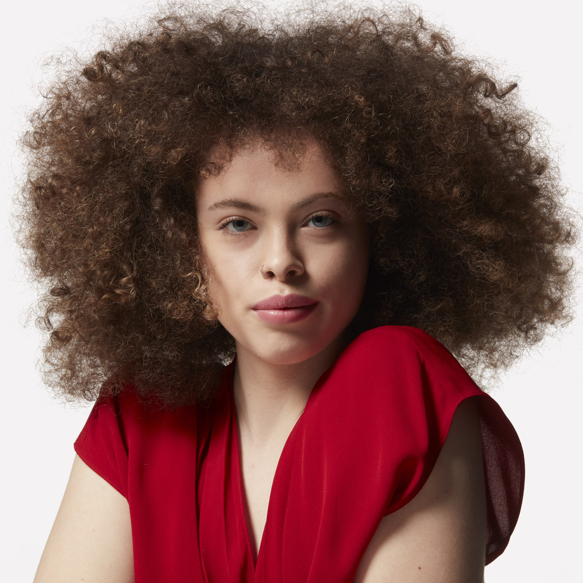 A model with a large curly afro