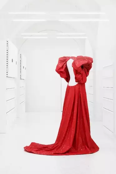 Mannequin bust wearing a backless red gown