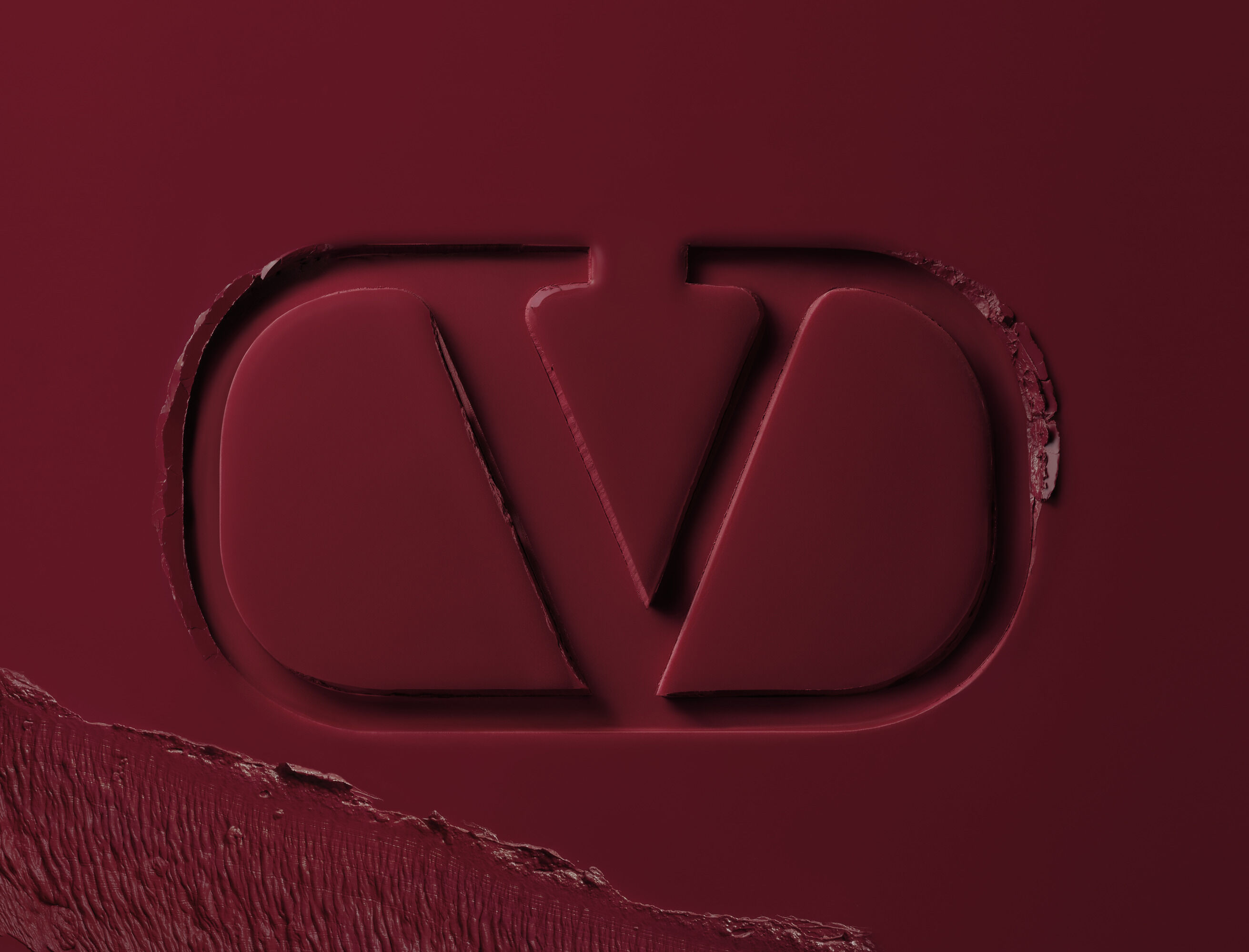Valentino Beauty logo embossed in burgundy lipstick formula