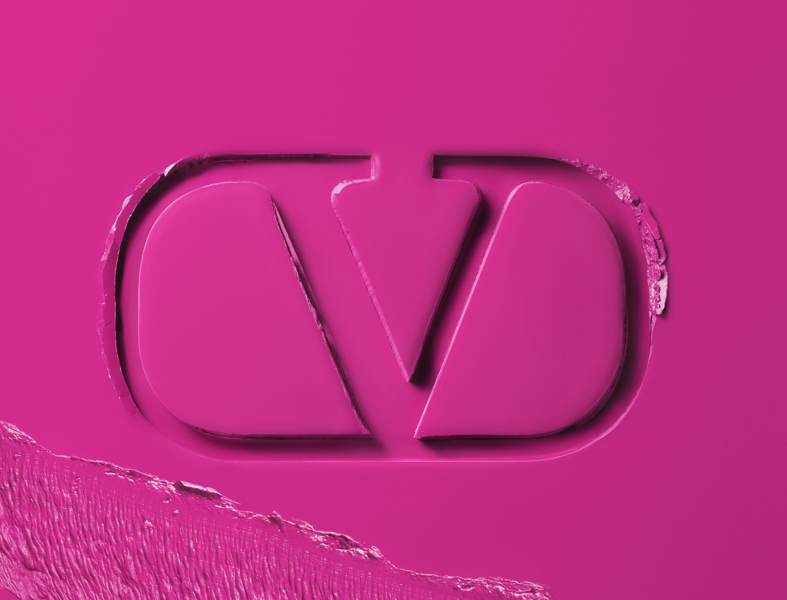 Valentino Beauty logo embossed in hot pink lipstick formula