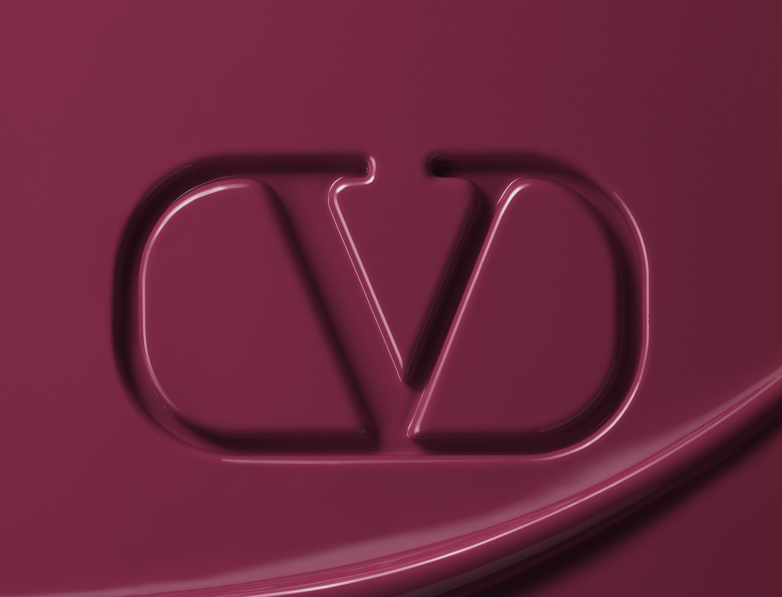 Valentino Beauty logo embossed in maroon lipstick formula