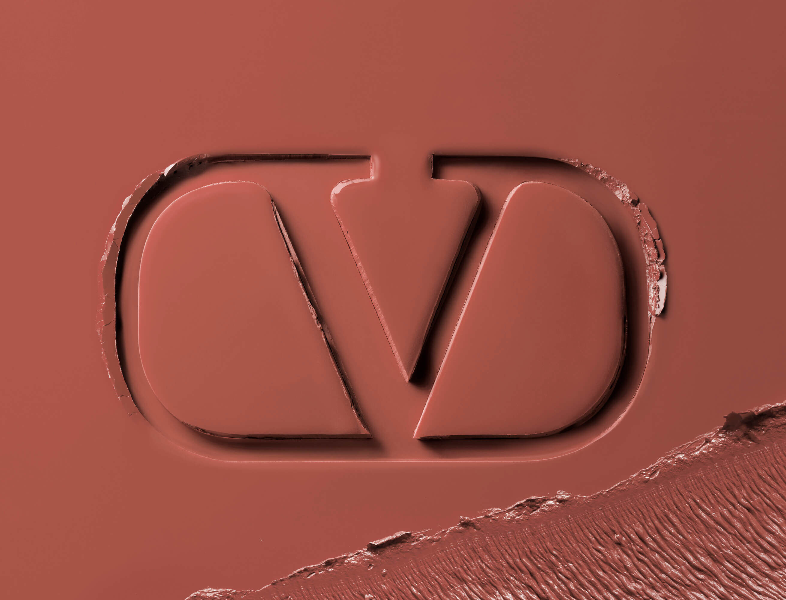 Valentino Beauty logo embossed in tan lipstick formula