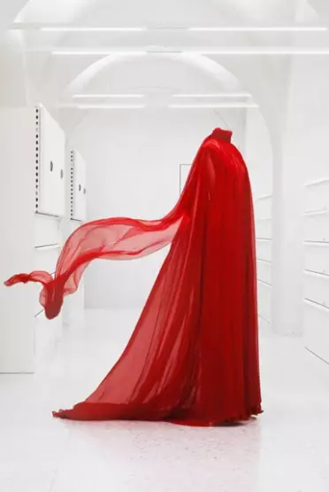 Mannequin bust wearing flowing red chiffon gown