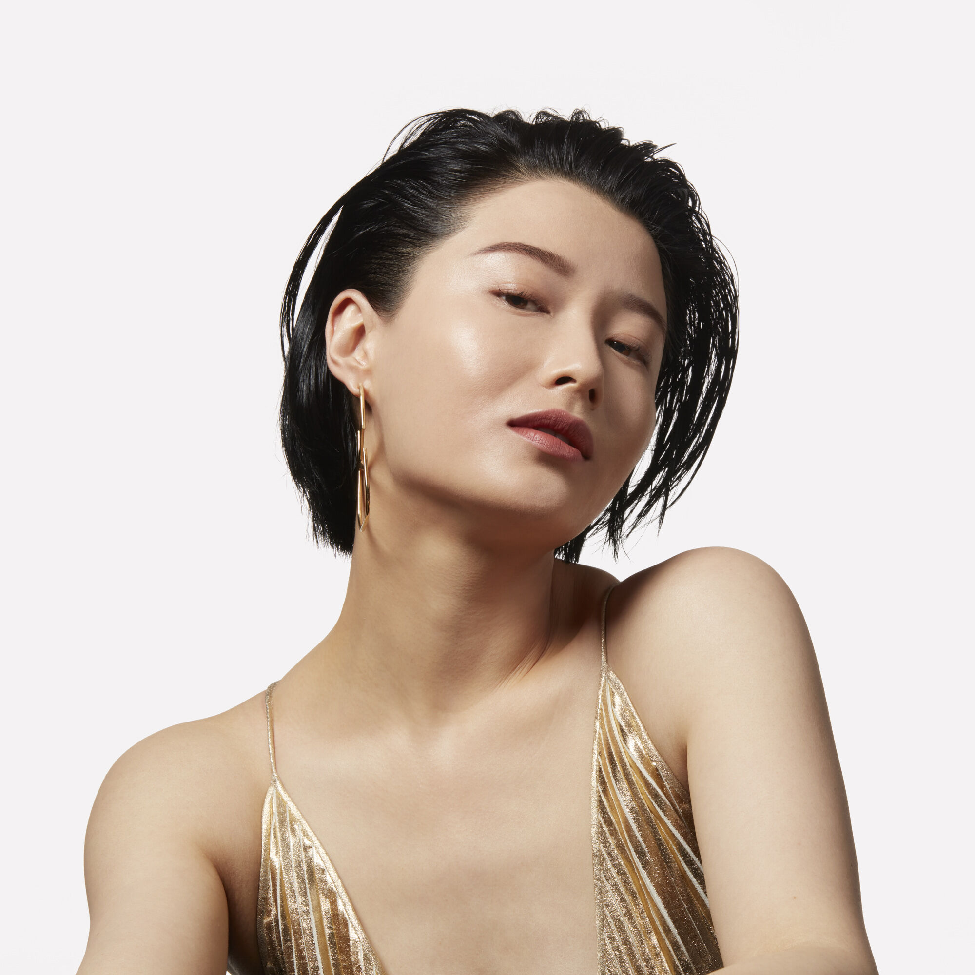 A model with slicked-back black hair
