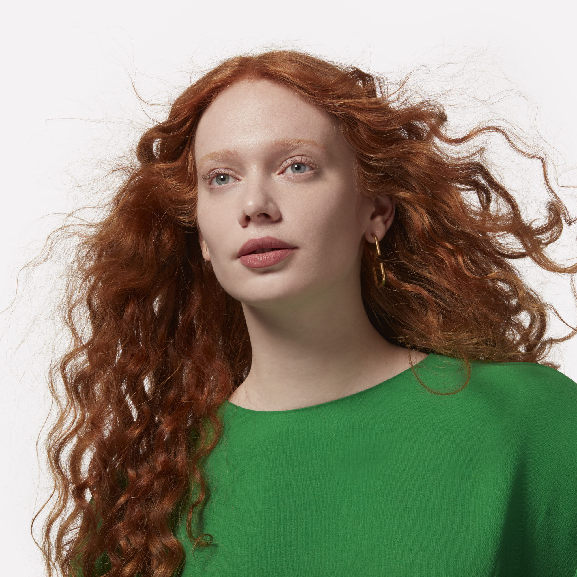 A model with long flowing wavy red hair