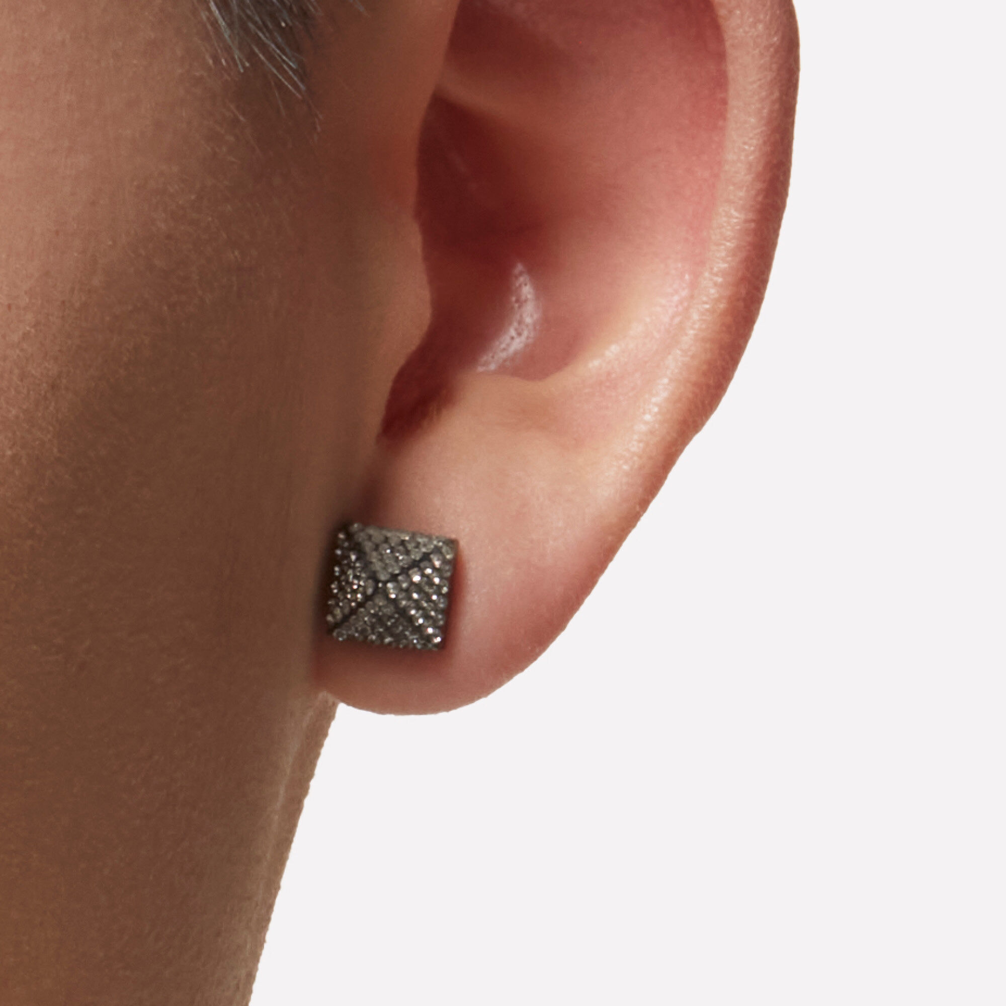 close-up of ear lobe wearing a diamond earring