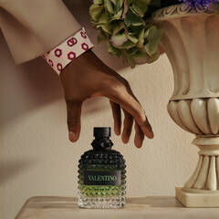 Hand grabbing cologne