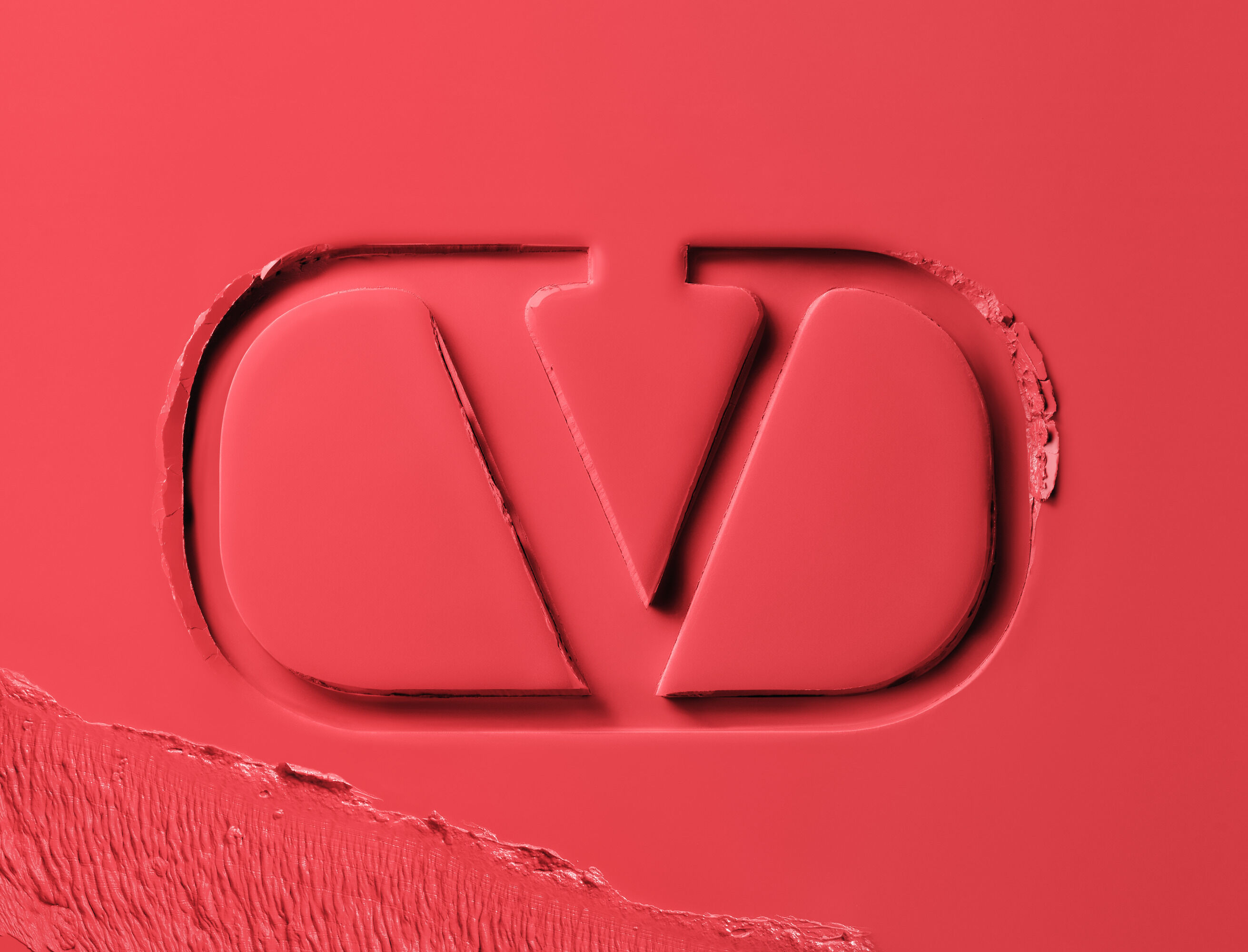 Valentino Beauty logo embossed in matte red lipstick formula